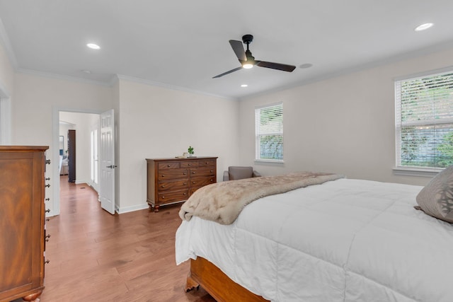 bedroom with hardwood / wood-style floors, crown molding, and ceiling fan