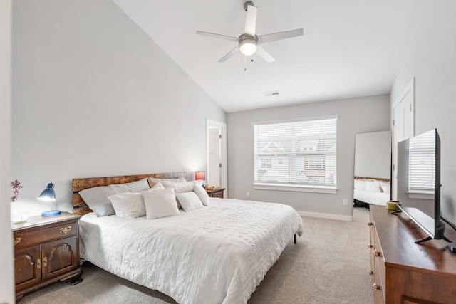 bedroom featuring ceiling fan, light colored carpet, and lofted ceiling