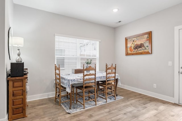 dining space featuring light wood-type flooring