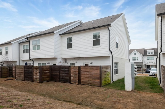 rear view of house with a yard