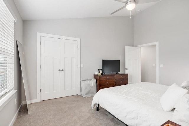 bedroom with light carpet, multiple windows, and vaulted ceiling