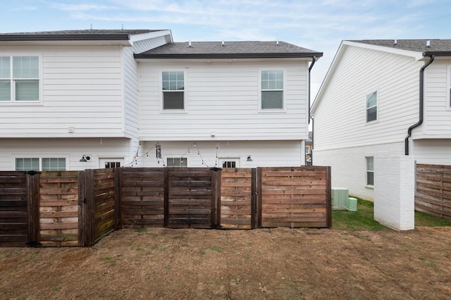 rear view of house with central AC