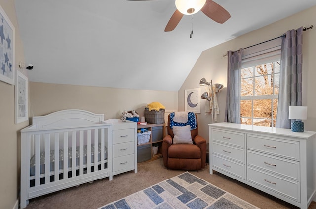 bedroom with a nursery area, ceiling fan, lofted ceiling, and light carpet