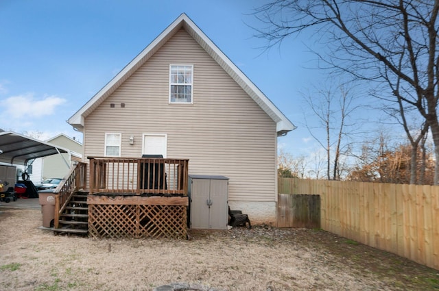 back of property featuring a carport and a wooden deck