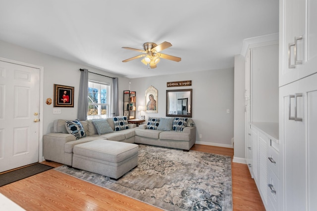 living room featuring ceiling fan and light hardwood / wood-style flooring