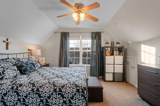 bedroom with vaulted ceiling, light colored carpet, and ceiling fan