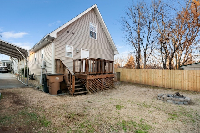 rear view of house featuring a deck and an outdoor fire pit