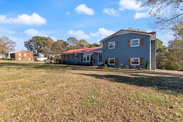 back of property with a lawn