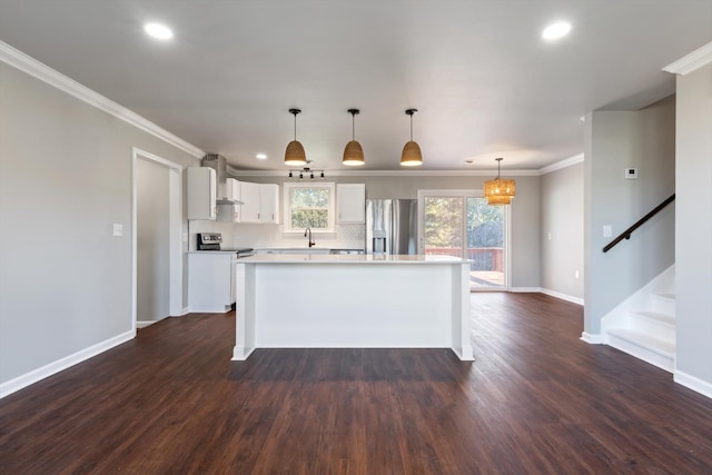 kitchen with a kitchen island, appliances with stainless steel finishes, decorative light fixtures, white cabinets, and dark hardwood / wood-style flooring