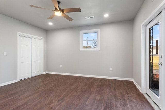 unfurnished bedroom featuring ceiling fan, dark hardwood / wood-style flooring, a closet, and access to exterior