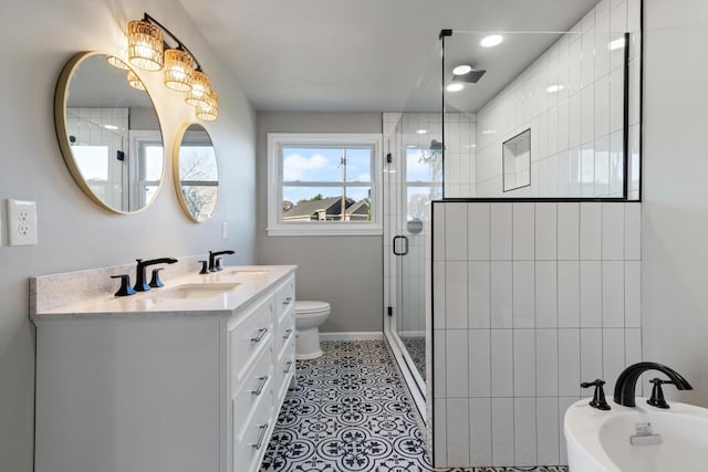 bathroom with vanity, tile patterned floors, toilet, and walk in shower