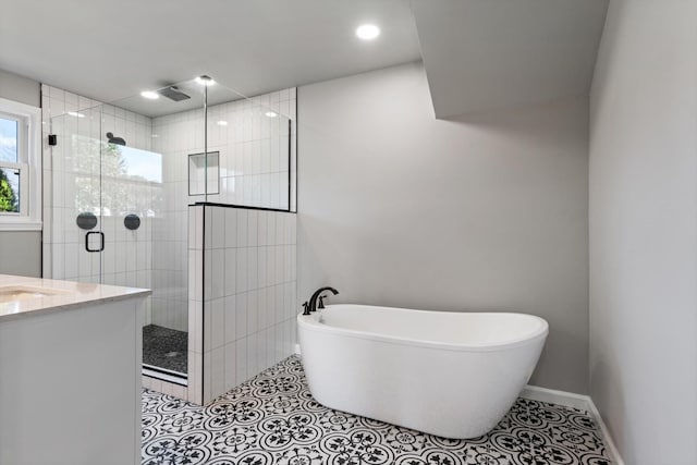 bathroom with shower with separate bathtub, tile patterned floors, and vanity