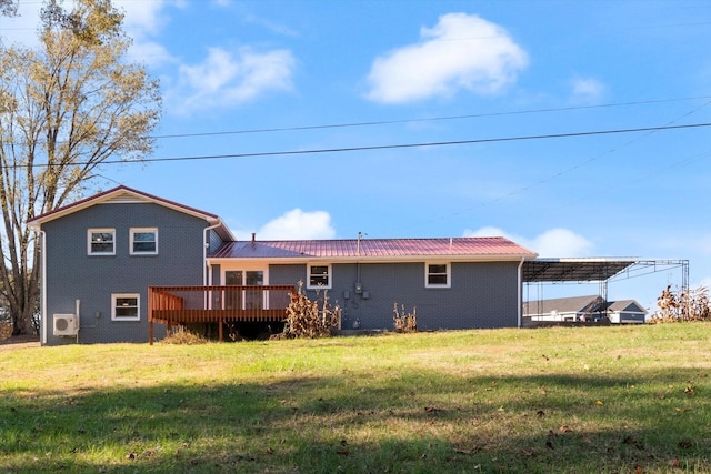 rear view of property with a yard and a deck