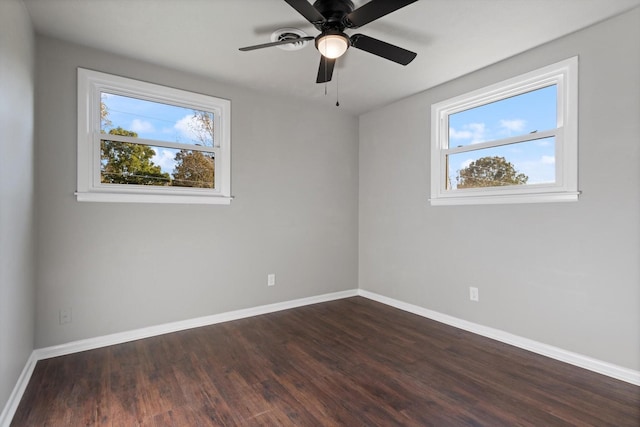 spare room with ceiling fan, dark hardwood / wood-style flooring, and a wealth of natural light