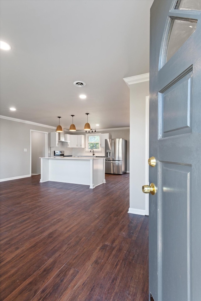 interior space with ornamental molding, dark hardwood / wood-style floors, and sink