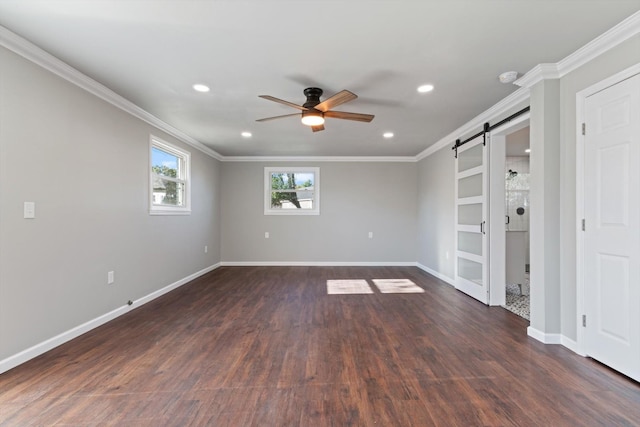 unfurnished room with ornamental molding, a barn door, ceiling fan, and dark hardwood / wood-style flooring