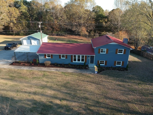 exterior space with a garage, an outdoor structure, and a yard