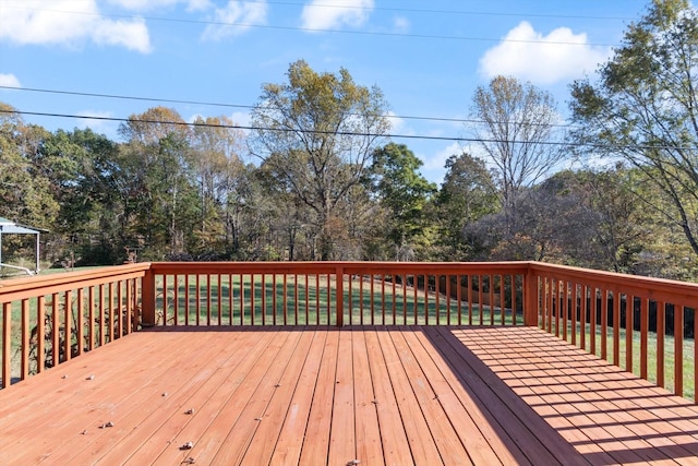 wooden terrace with a lawn