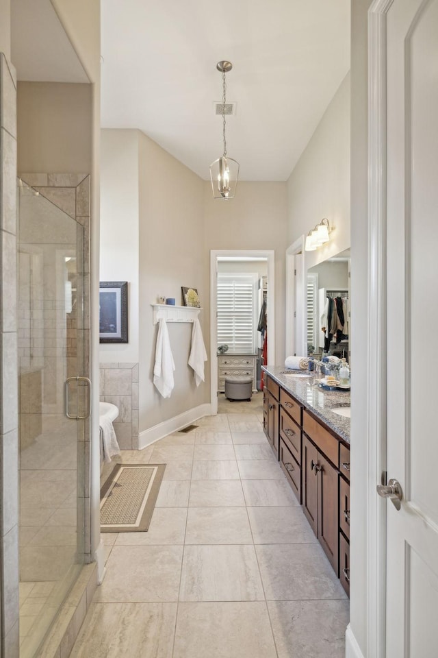 bathroom featuring a chandelier, vanity, and separate shower and tub