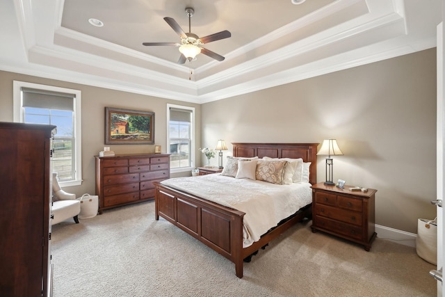 bedroom featuring crown molding, light colored carpet, and a raised ceiling