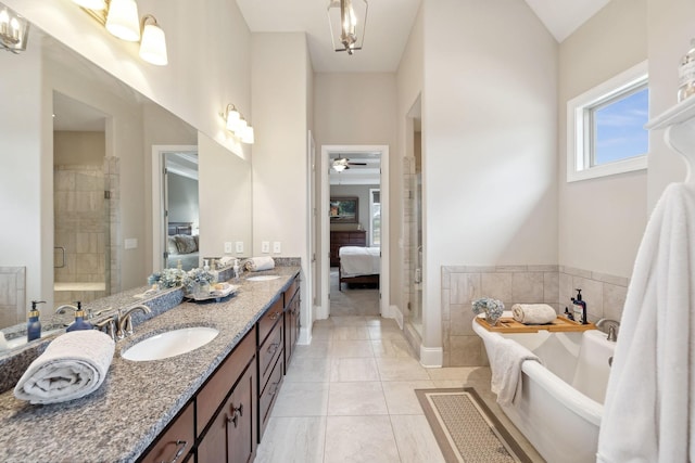 bathroom featuring vanity, tile patterned flooring, and shower with separate bathtub