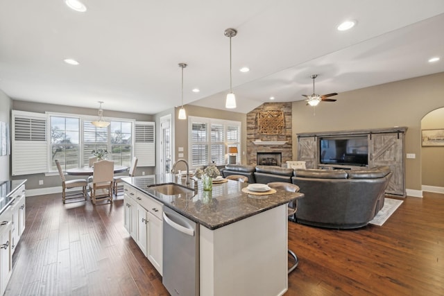 kitchen with dishwasher, sink, white cabinets, and dark stone counters