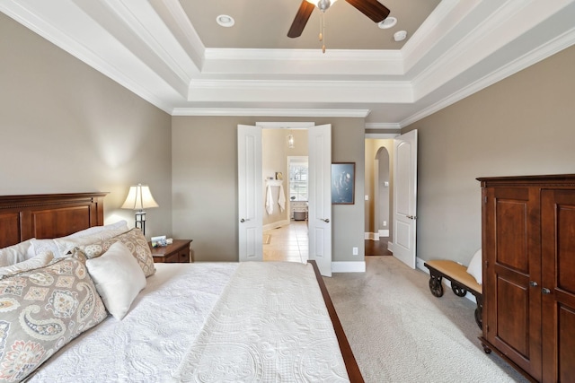 carpeted bedroom with crown molding, ceiling fan, and a tray ceiling