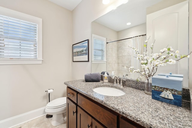 bathroom with tile patterned flooring, vanity, toilet, and walk in shower