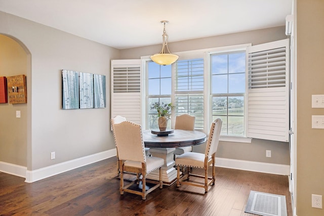 dining area with dark hardwood / wood-style flooring