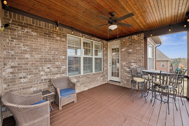 wooden deck featuring ceiling fan