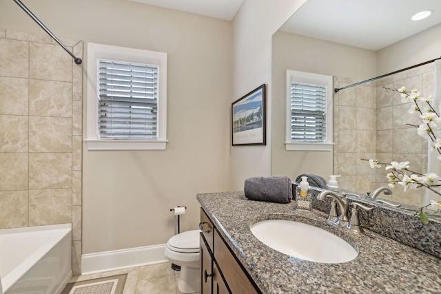 full bathroom with tile patterned flooring, vanity, tiled shower / bath combo, and toilet