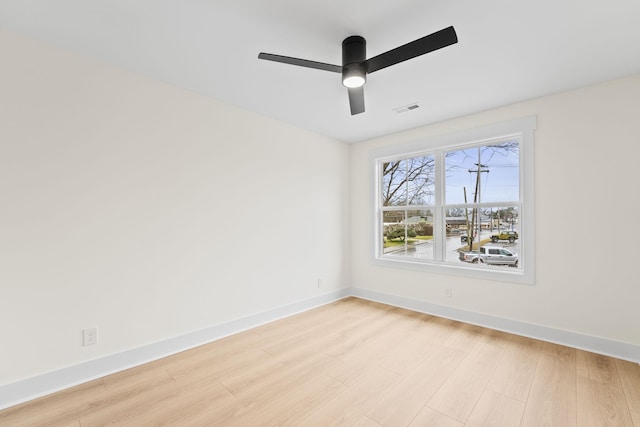 spare room featuring light hardwood / wood-style flooring and ceiling fan