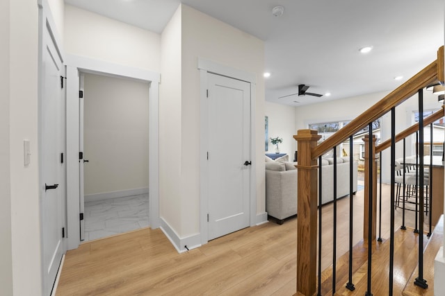 hallway with light hardwood / wood-style flooring