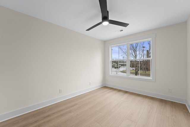 spare room with ceiling fan and light wood-type flooring