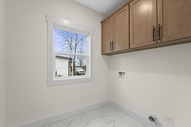 clothes washing area featuring electric dryer hookup, hookup for a washing machine, and cabinets