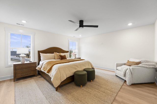 bedroom with ceiling fan and light hardwood / wood-style floors