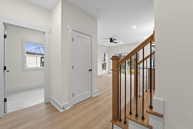 corridor featuring a healthy amount of sunlight and light hardwood / wood-style flooring