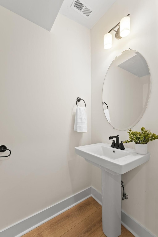 bathroom with wood-type flooring