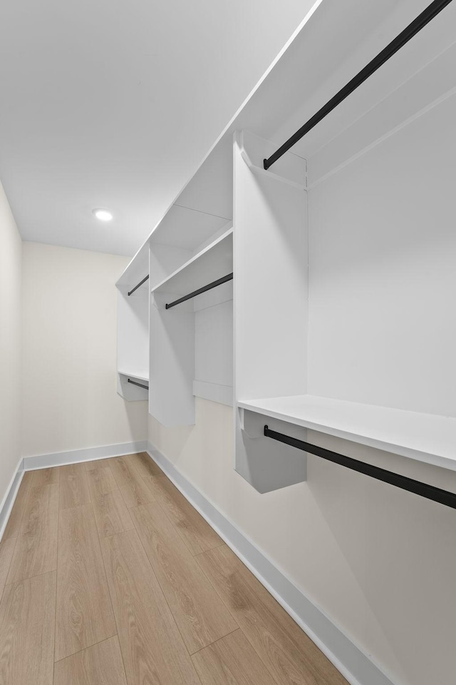 walk in closet featuring light hardwood / wood-style flooring