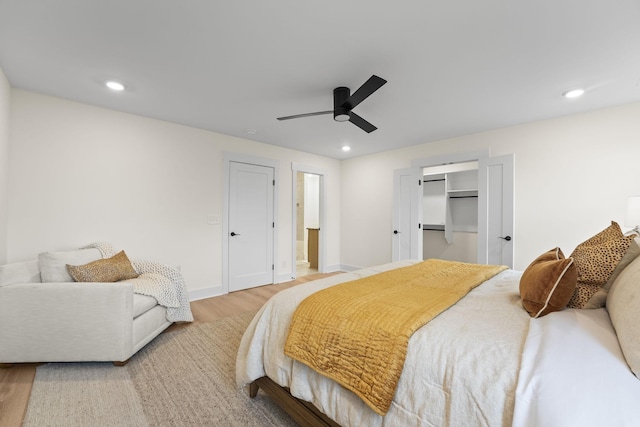 bedroom with ceiling fan and light hardwood / wood-style floors