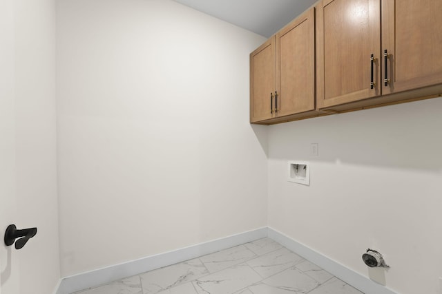 laundry room with washer hookup and cabinets