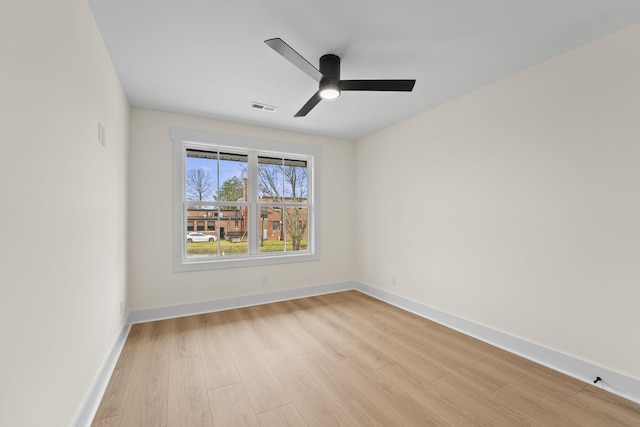 empty room featuring ceiling fan and light hardwood / wood-style floors