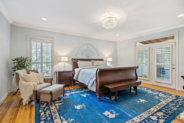 bedroom with hardwood / wood-style flooring, ornamental molding, access to outside, and a chandelier