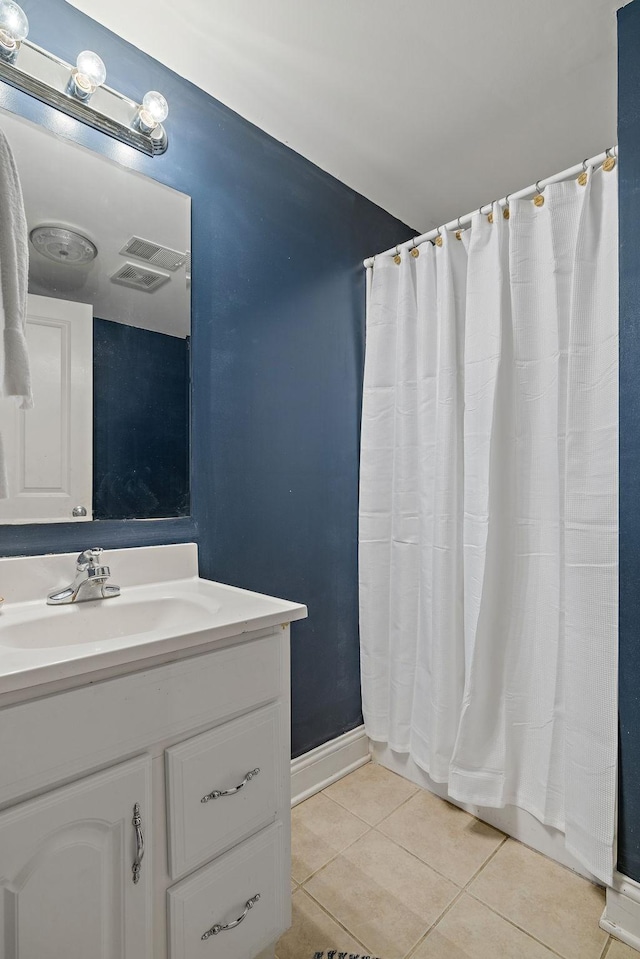 bathroom featuring tile patterned flooring, vanity, and a shower with shower curtain