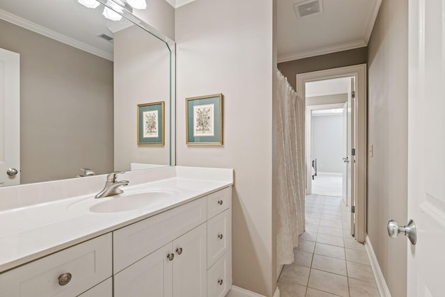 bathroom with tile patterned flooring, crown molding, and vanity