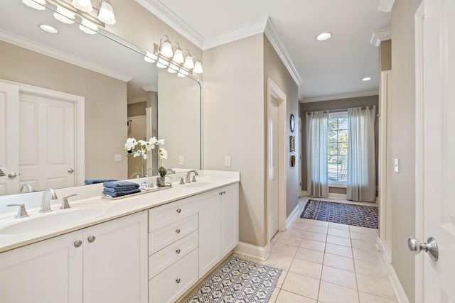 bathroom featuring tile patterned flooring, crown molding, and vanity