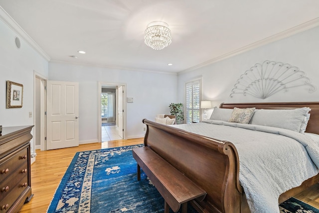 bedroom featuring crown molding, a chandelier, and light wood-type flooring