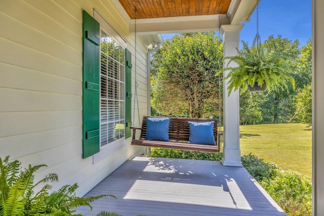 exterior space with a porch and a lawn