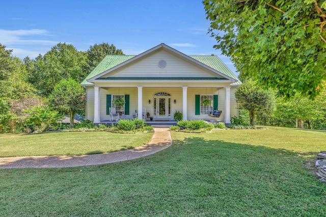 neoclassical / greek revival house featuring covered porch and a front lawn