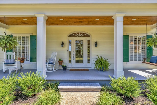 view of exterior entry with covered porch